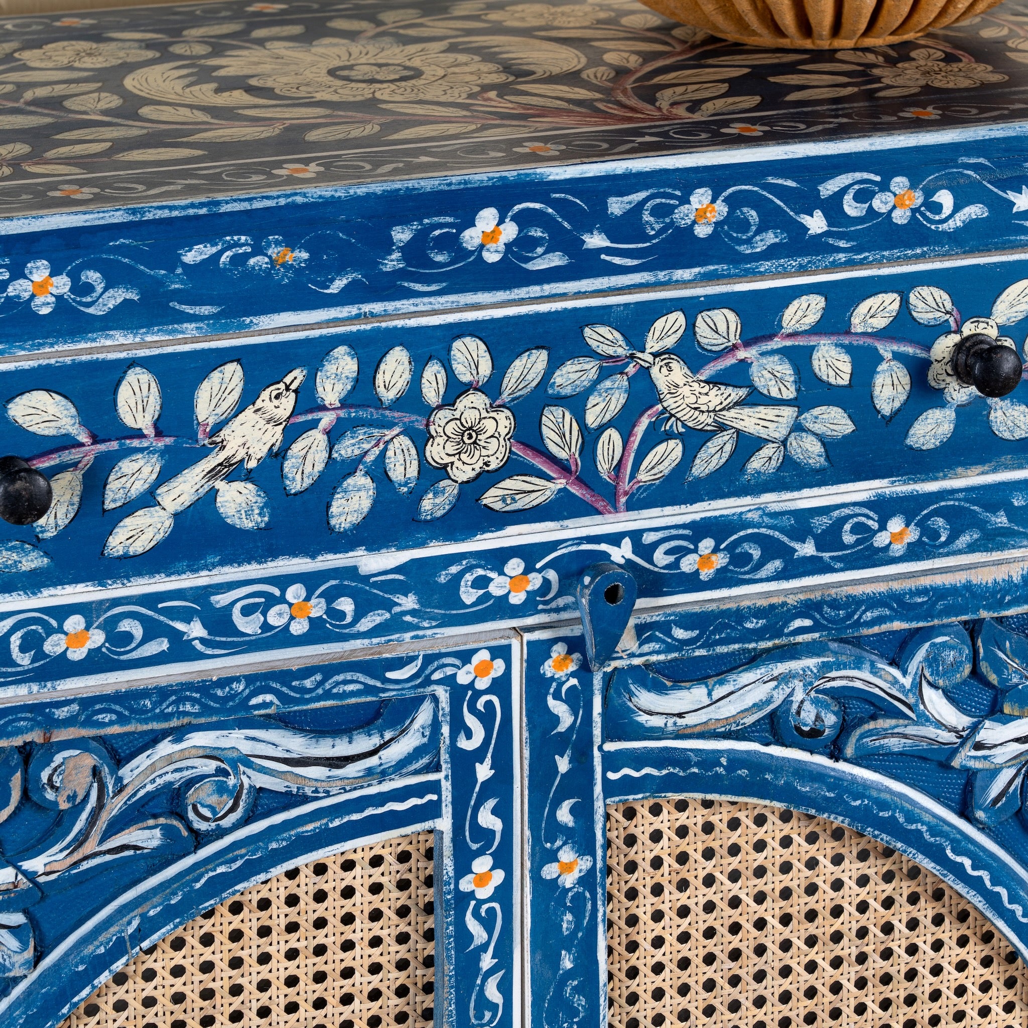 Close up image of a Satya hand painted reclaimed wood cabinet with natural rattan doors 105cm