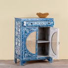 Side angle image with open door of a Satya hand painted reclaimed wood cabinet with natural rattan doors 105cm
