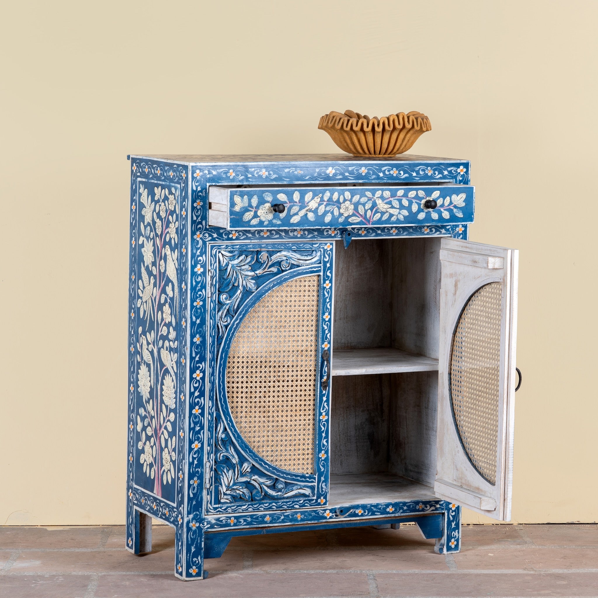 Side angle image with open door of a Satya hand painted reclaimed wood cabinet with natural rattan doors 105cm