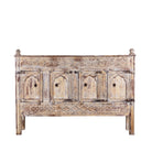 White background image of a Satyam hand carved reclaimed wood sideboard with four arched doors and distressed cream vintage finish 153cm