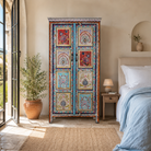 Lifestyle image of a Saya hand painted reclaimed wood cabinet with colourful Indian artwork 180cm