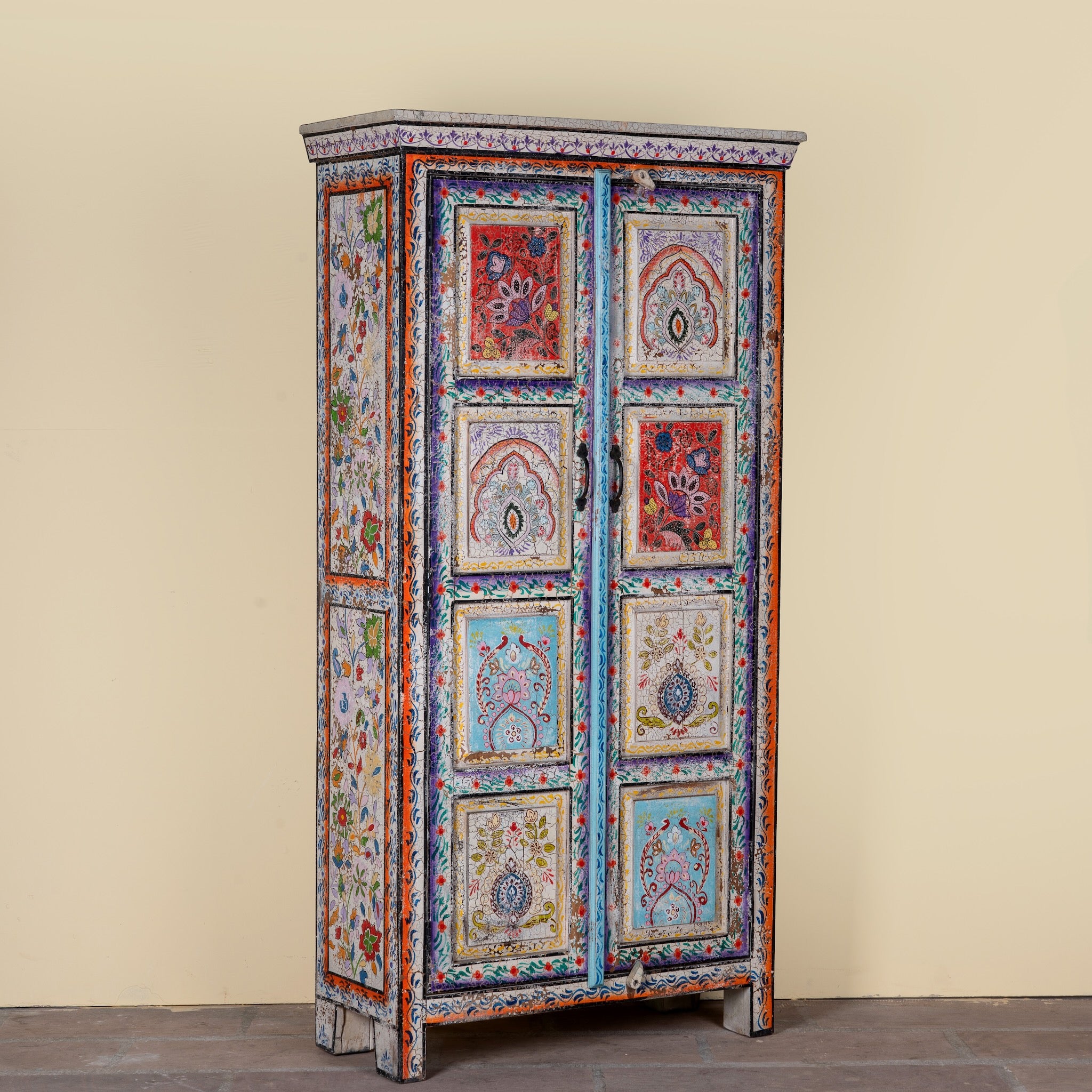 Side angle image of a Saya hand painted reclaimed wood cabinet with colourful Indian artwork 180cm