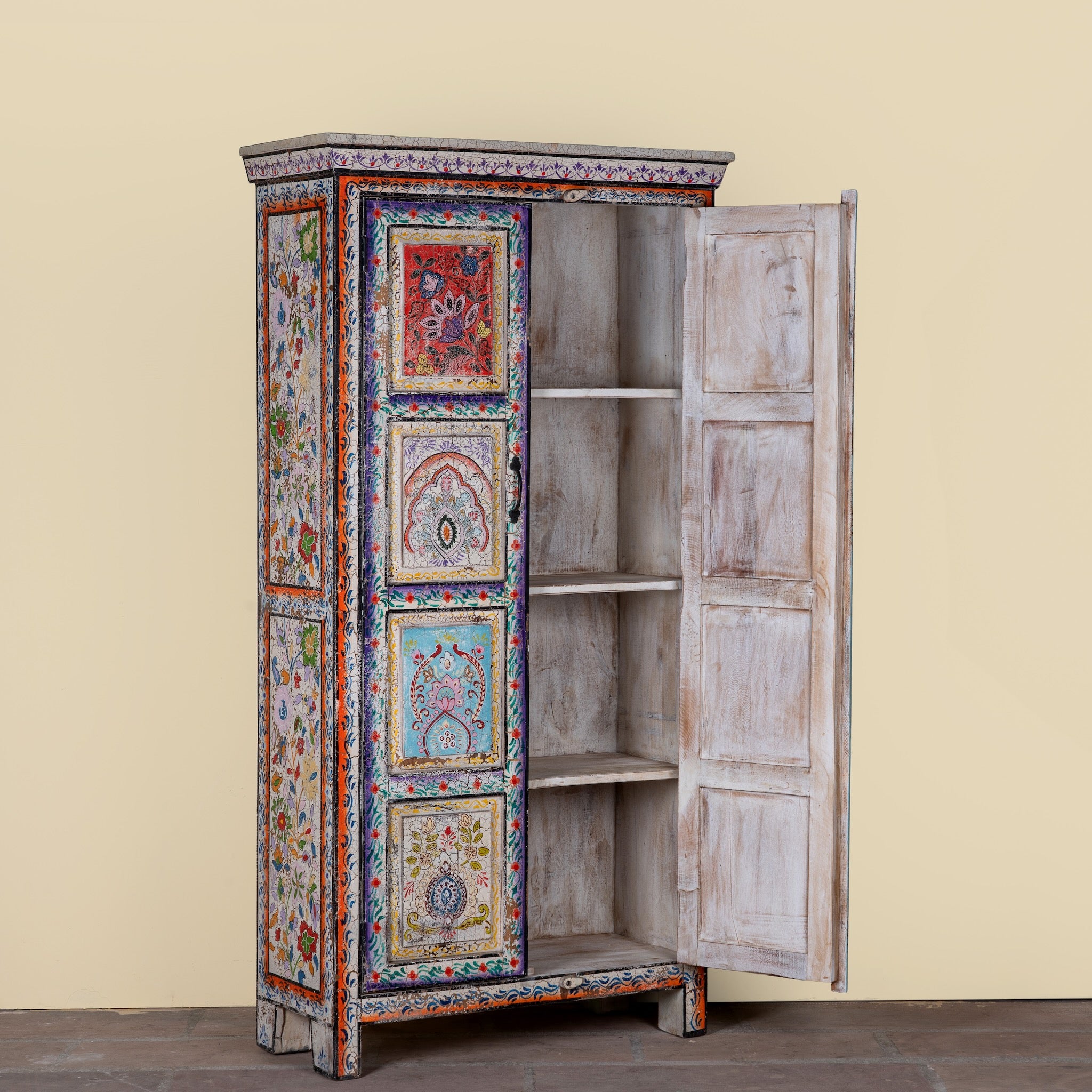 Side angle image with open door of a Saya hand painted reclaimed wood cabinet with colourful Indian artwork 180cm