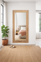 Lifestyle imagination of a reclaimed wood mirror Aranyani with sanded beach wood texture and minimalist design. A Japandi style mirror handcrafted in Rajasthan, offering rustic charm and sustainable elegance.