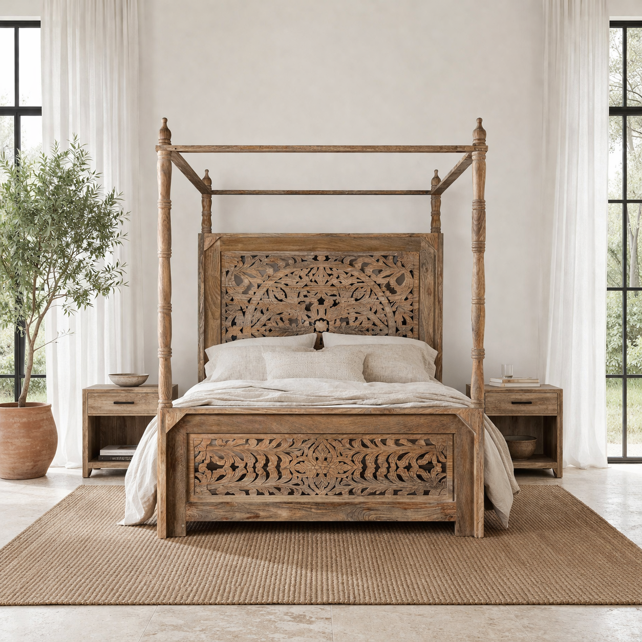 Lifestyle image of a wooden canopy bed with carved headboard in a bedroom with a plant and open door