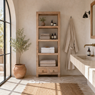 Lifestyle image of a Shailee tall mango wood shelving unit with open shelves and two drawers 190cm