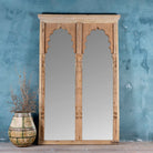 Antique Indian arch mirror Shalee made from a reclaimed teak wood double window with carved arches. A unique piece of rustic wall art and functional décor for bohemian or vintage-inspired interiors.