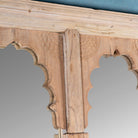 Close up image of a antique Indian arch mirror Shalee made from a reclaimed teak wood double window with carved arches. A unique piece of rustic wall art and functional décor for bohemian or vintage-inspired interiors.
