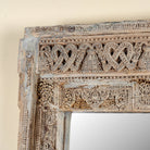 Close up image of a unique antique reclaimed teak wood wall mirror crafted from a hand carved window frame with bleached finish, Shanika 110x15x176cm
