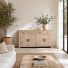 Lifestyle scene with a hand-carved mango wood sideboard with sandblasted finish – a rustic mango wood furniture piece ideal for Ibiza style interiors.