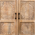 Close up image of a Sharad hand-carved reclaimed wood cabinet with two carved doors and natural aged wood character.