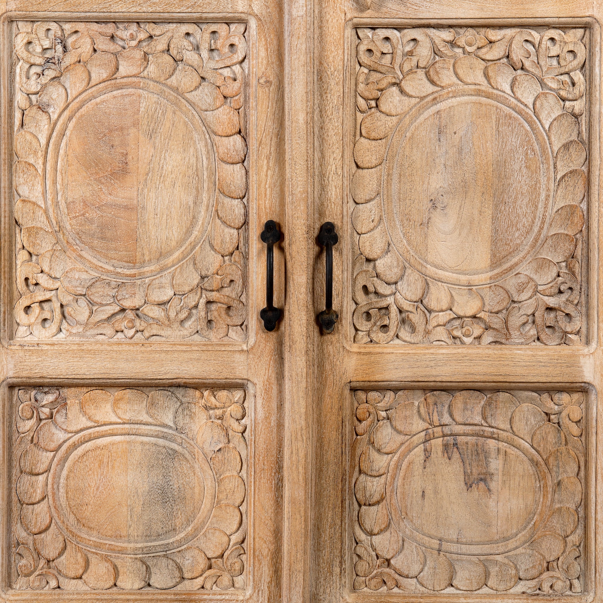 Close up image of a Sharad hand-carved reclaimed wood cabinet with two carved doors and natural aged wood character.