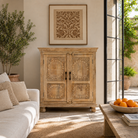 Lifestyle image of a Sharad hand-carved reclaimed wood cabinet with two carved doors and natural aged wood character.