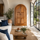 Livestyle image of a Shivaaya hand carved mango wood cabinet with geometric double doors and arched top 210cm