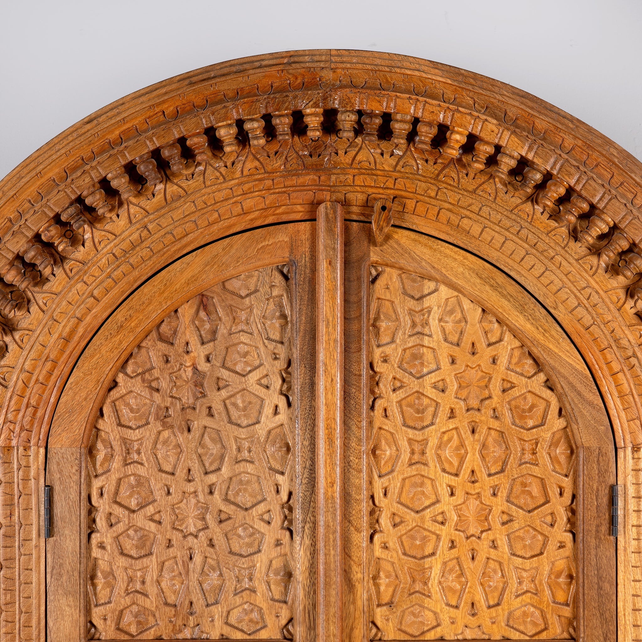 Shivaaya hand carved mango wood cabinet with geometric double doors and arched top 210cm