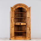 Image showing open doors of a Shivaaya hand carved mango wood cabinet with geometric double doors and arched top 210cm