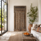 Lifestyle image of a Shomil antique hand carved Indian teak wood door wall decoration 222cm