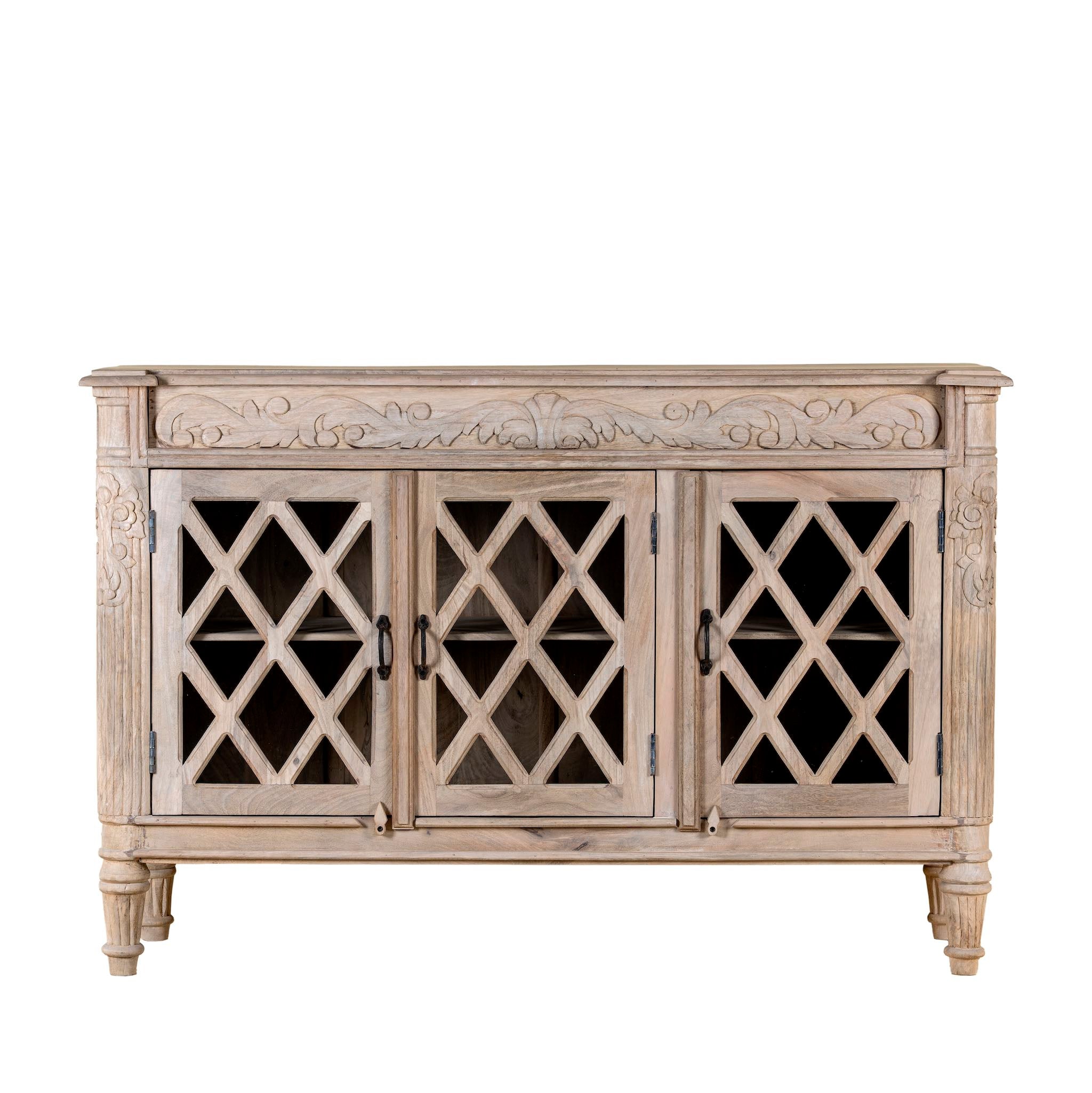 White background image of a rustic sideboard made of Mango wood with hand-carved details and glass panelled doors featuring a diamond lattice design.