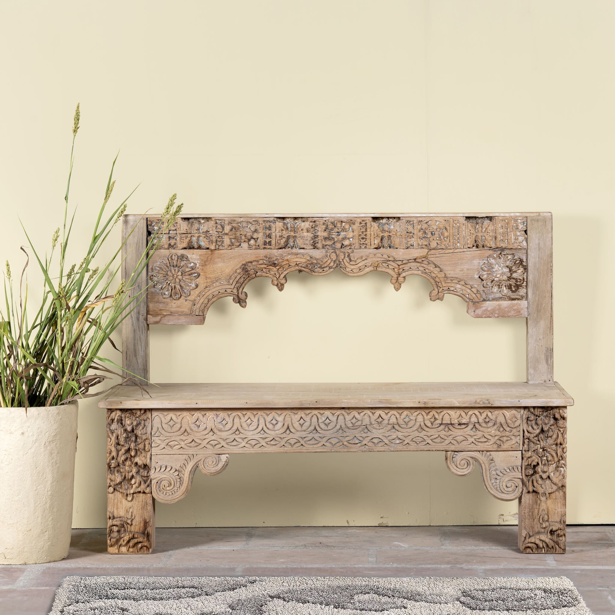 Shraddha bench made from bleached reclaimed teak wood with intricate hand-carved floral details, showcasing traditional Indian craftsmanship and sustainable furniture design.