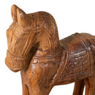 Close up image of a hand-carved wooden horse sculpture made from reclaimed wood – Indian vintage home accessory with traditional saddle carving.