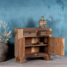 Open door view of a driftwood cabinet made from reclaimed wood with panelled doors, drawers, and rustic finish, 90 × 40 × 90 cm.