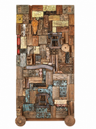 Reclaimed teak wood partition on wheels made from old doors, windows, and furniture pieces, with warm brown tones and colourful details.