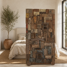 Lifestyle image of a reclaimed teak wood partition on wheels made from old doors, windows, and furniture pieces, with warm brown tones and colourful details.