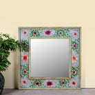 Snehal hand-painted reclaimed wood wall mirror featuring colourful floral artwork and artisan detailing, 90x90cm.