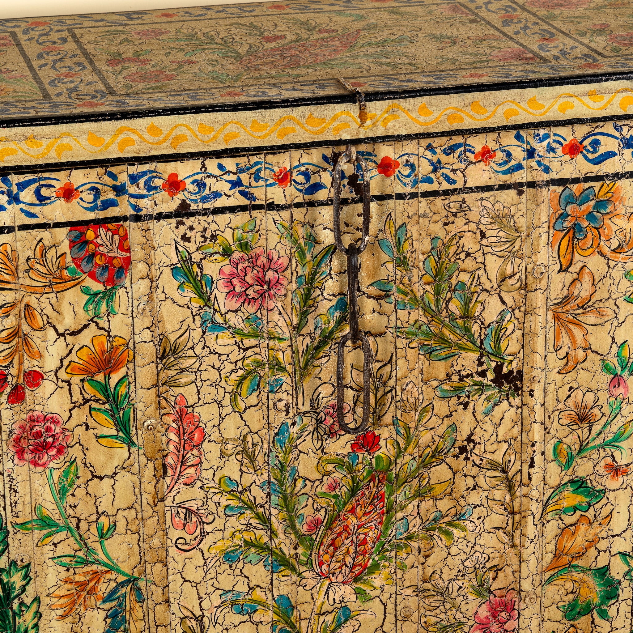 Close up image of a Soham hand painted reclaimed teak wood storage box with colourful floral and botanical motifs 141cm
