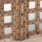 Close-up of a wooden door mirror made from antique teak, part of our Indian home decor collection with original carvings and iron accents.