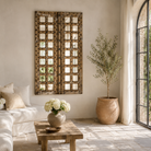 Lifestyle image of a wooden door mirror made from antique teak, part of our Indian home decor collection with original carvings and iron accents.