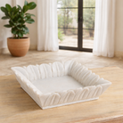 Lifestyle imagination of a square hand-carved white marble bowl with petal-like edges – decorative Indian marble accessory.