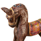 Close up image of a hand-painted decorative wooden horse made from reclaimed wood with colourful saddle design – a vintage Indian home accessory full of character.