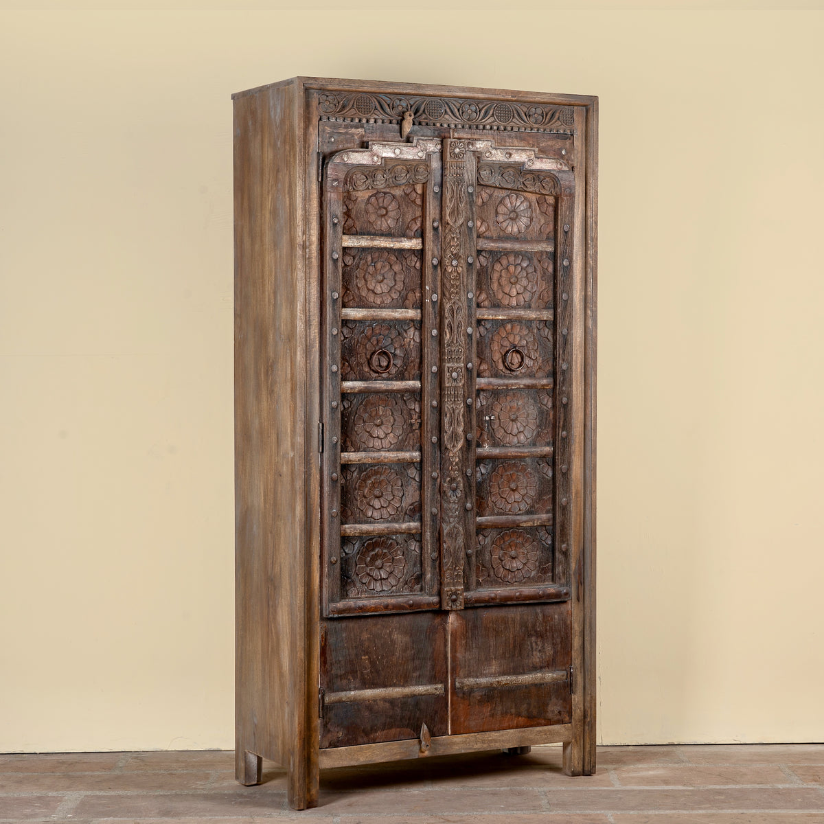 Side angle image of a Srinika vintage Indian wardrobe with mango wood body and old hand-carved teak house door, 94x42x195cm