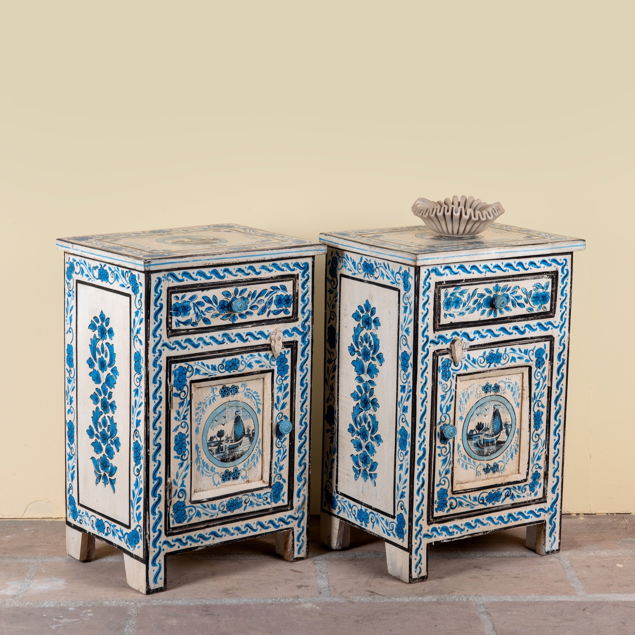 Side angle image of a Suhasin limited edition reclaimed wood bedside table set with Delft inspired hand painted motifs