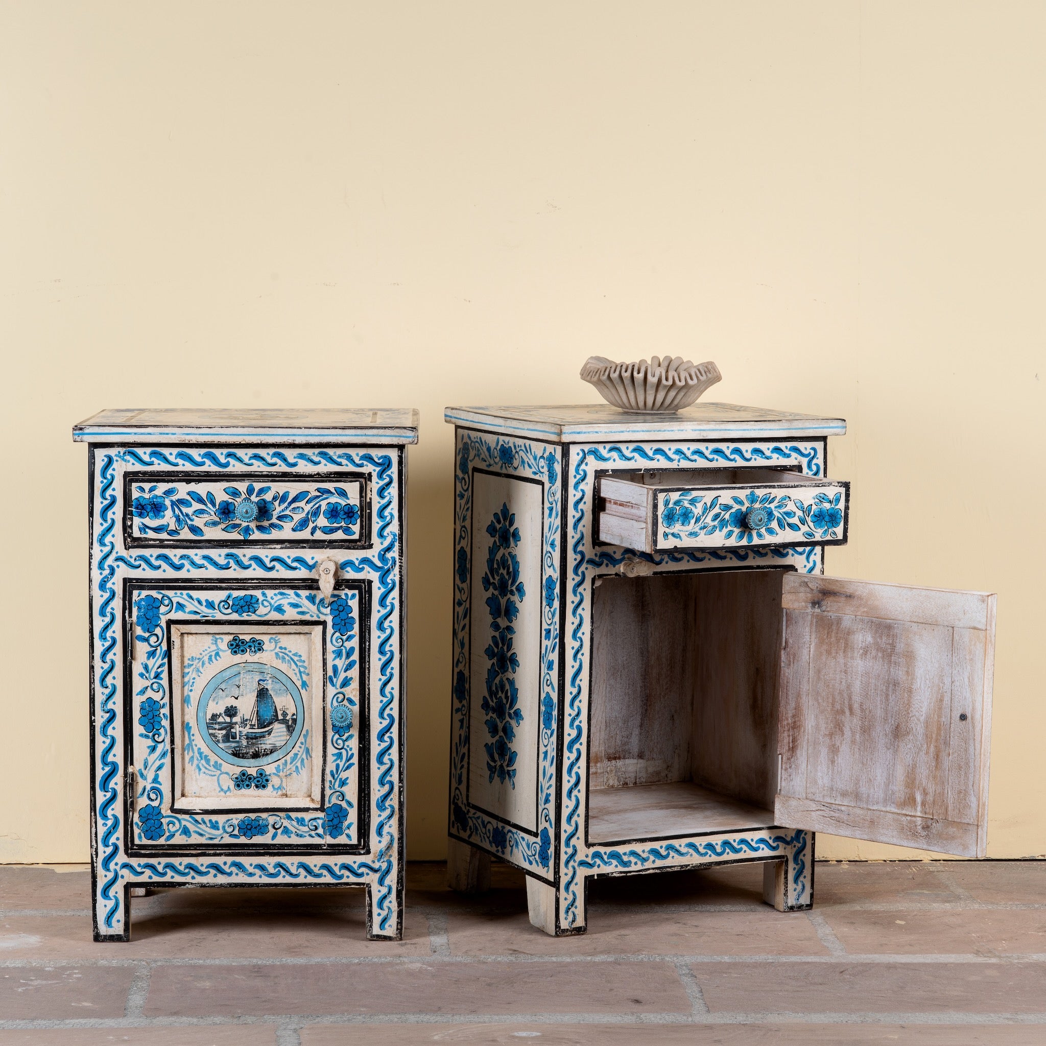 Side angle image with open door of a Suhasin limited edition reclaimed wood bedside table set with Delft inspired hand painted motifs