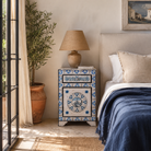 Lifestyle image of a Sunaina limited edition reclaimed wood bedside table set with Delft inspired hand painted motifs