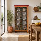 Lifestyle image of a hand-painted reclaimed wood showcase with floral motifs and glass doors – sustainable furniture combining vintage charm and traditional craftsmanship.