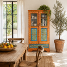Lifestyle image of a hand painted reclaimed wood showcase with 2 doors and one drawer.