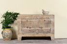 Sideboard Taksh made from reclaimed teak wood, featuring carved antique Indian door fronts with circular mandala motifs. A unique piece of old door furniture combining Mediterranean style with traditional Indian craftsmanship.