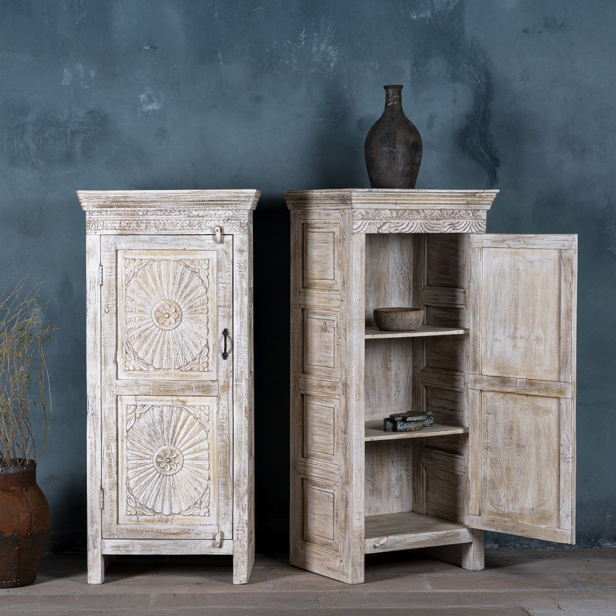 Open door image of a white washed wood cabinet with hand-carved floral design, Moroccan-style reclaimed wood furniture, 134 × 60 × 45 cm.