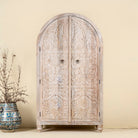 Handcrafted mango wood wardrobe with arched top and floral carving – Tamia by Om Home & Garden, unique furniture with Ibiza-style charm for living rooms and bedrooms.