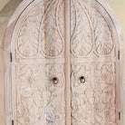 Close up image of a handcrafted mango wood wardrobe with arched top and floral carving – Tamia by Om Home & Garden, unique furniture with Ibiza-style charm for living rooms and bedrooms.