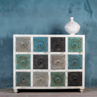 Carved mango wood chest of drawers with twelve multicolour floral drawer fronts, 124 × 40 × 102 cm.