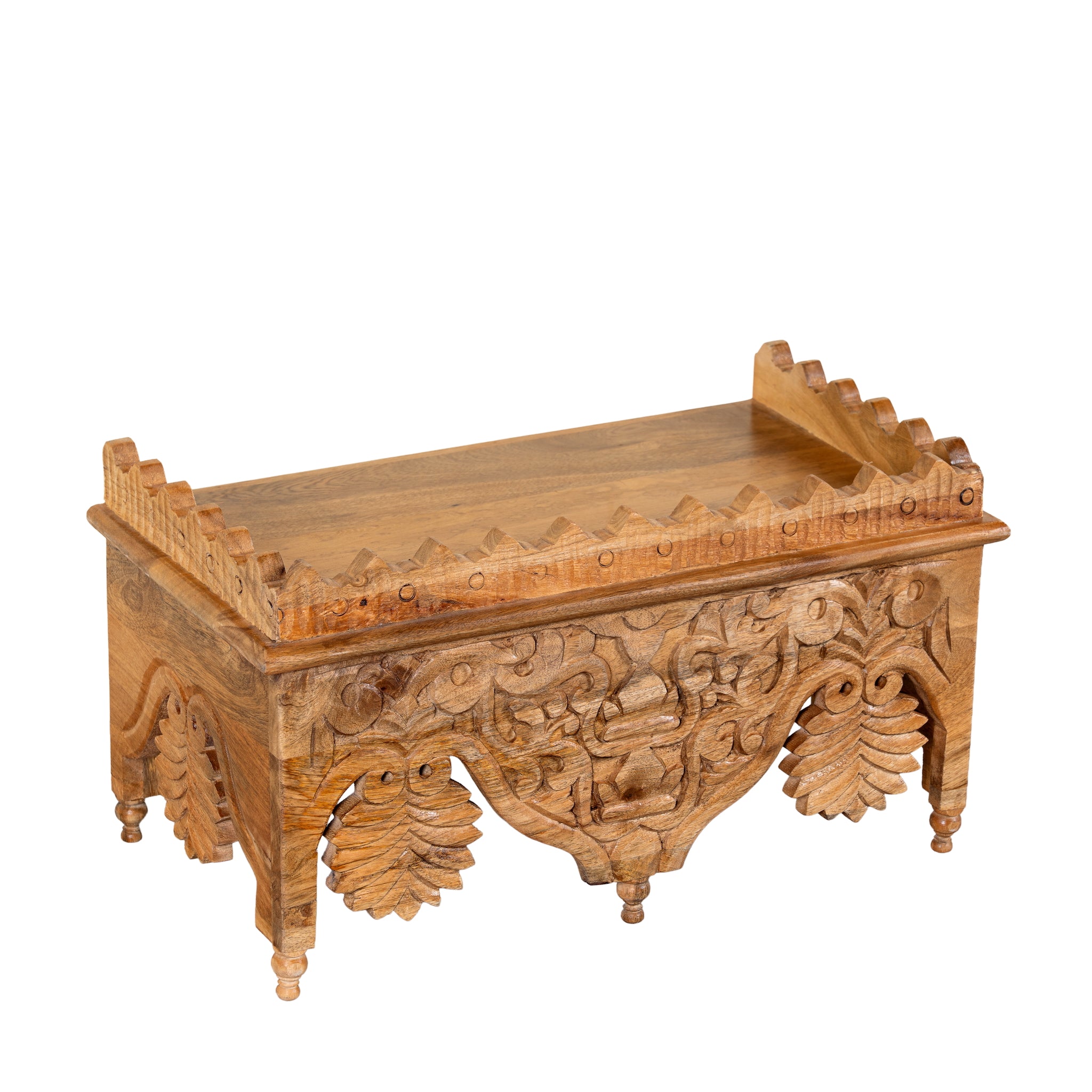 Side angle image of a Tanira hand carved mango wood wall shelf with floral carvings and decorative hanging leaf details 60cm