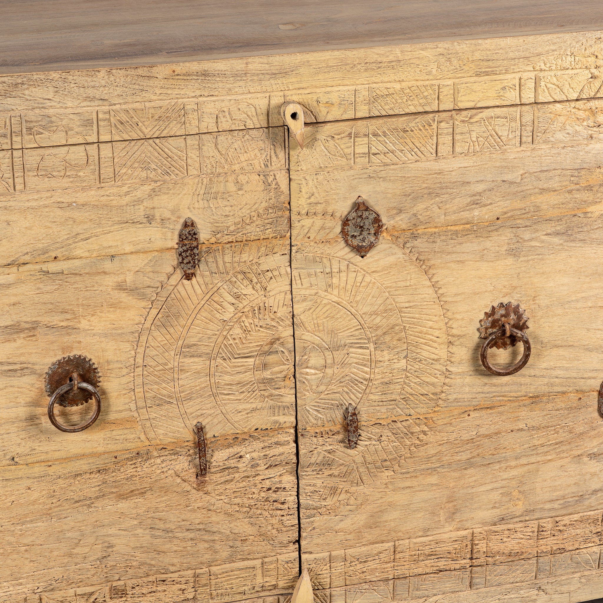 Close up image of a Tarini reclaimed teak wood sideboard with hand carved Orissa house door elements and original iron fittings 132cm