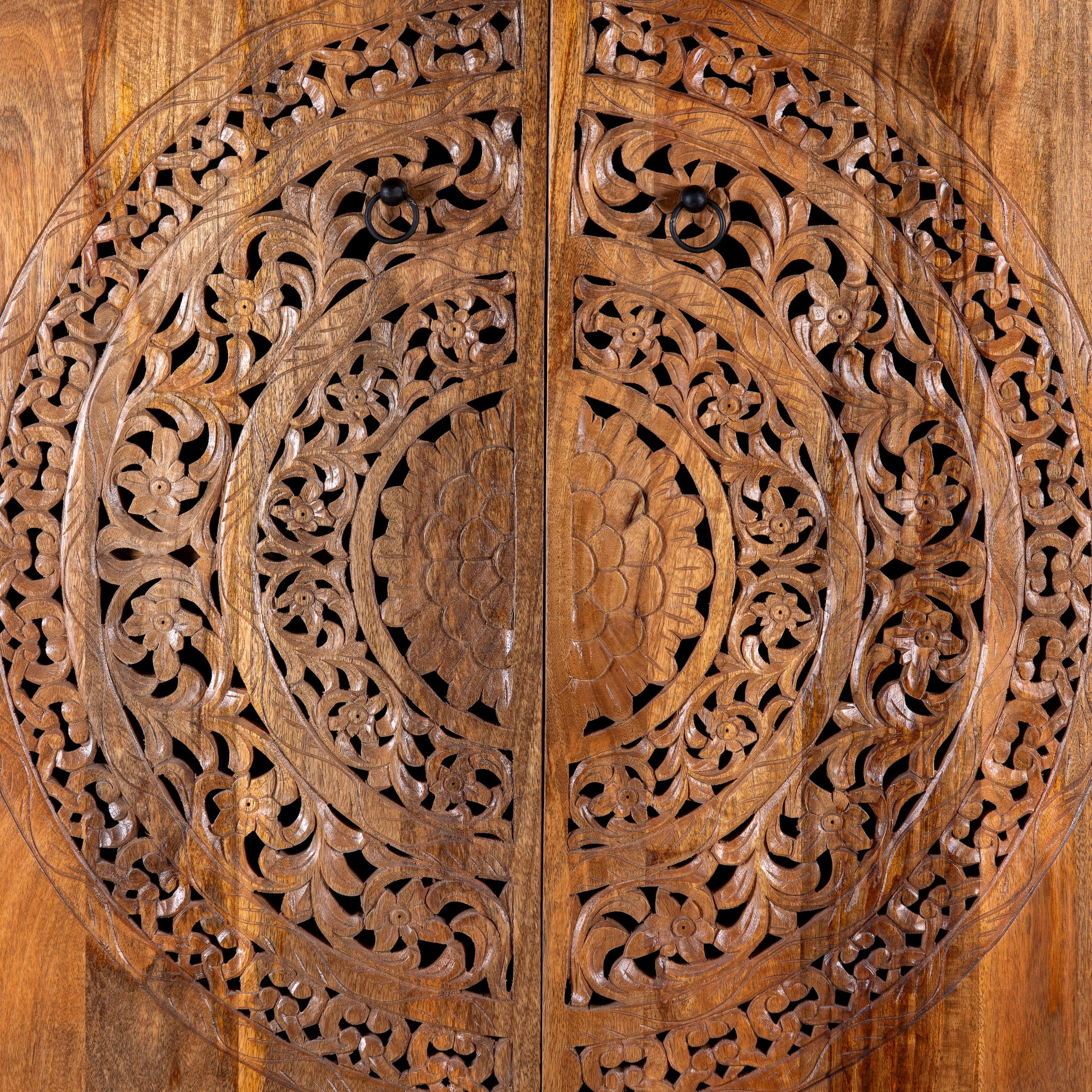 Close up image of a Tash hand carved mango wood wardrobe with mandala carved doors, hanging rail and four storage compartments, 108x55x190cm