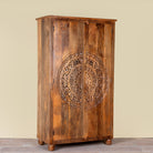 Side angle image of a Tash hand carved mango wood wardrobe with mandala carved doors, hanging rail and four storage compartments, 108x55x190cm