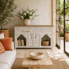 Lifestyle image of a Teerth hand carved white washed mango wood console table with natural wood top 150cm