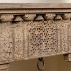 Close up image of a handcrafted entryway table vintage, unique furniture in reclaimed teak wood with floral and geometric carvings, 160 × 40 × 90 cm.